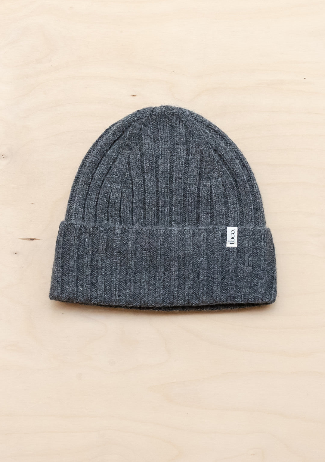 TBCo Cashmere & Merino Beanie in charcoal melange, featuring ribbed texture and folded brim with signature label detail