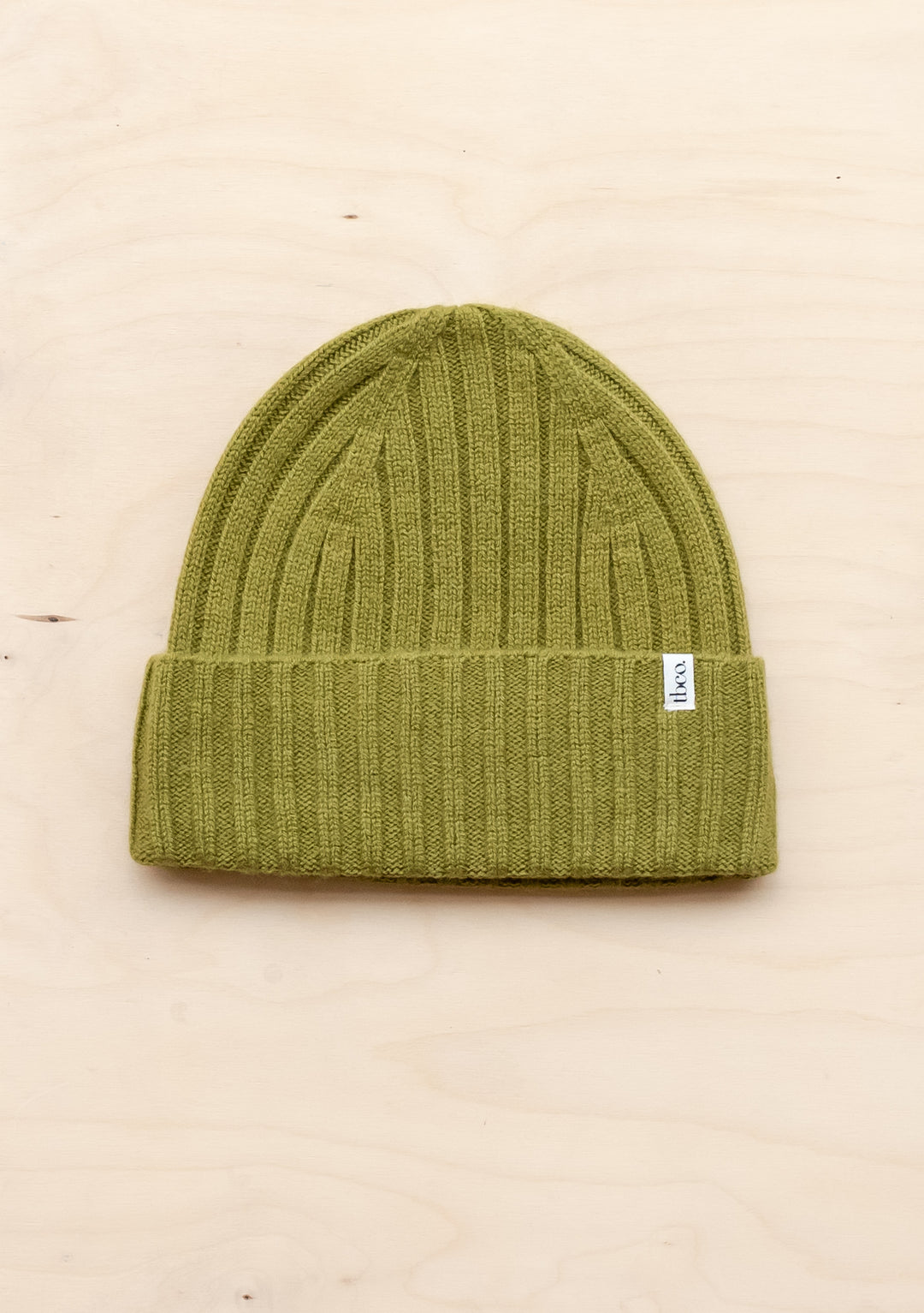 TBCo olive cashmere and merino wool beanie with ribbed texture and folded brim, showcasing luxury winter warmth