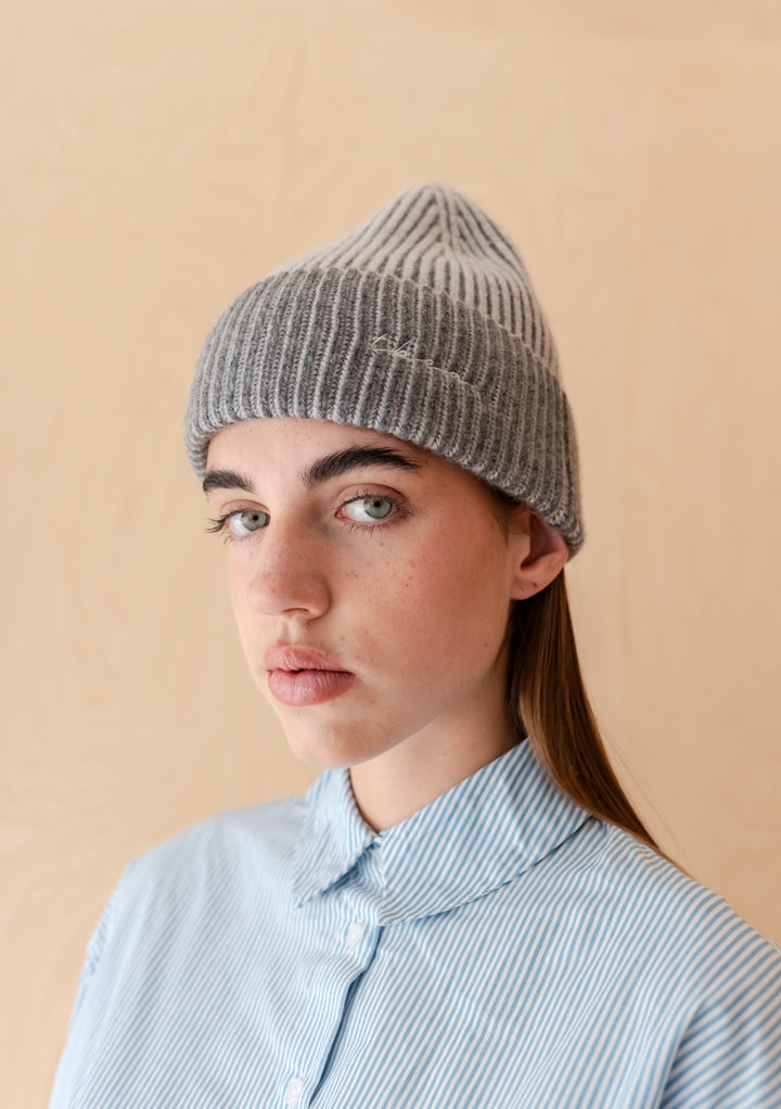 Woman wearing TBCo Cashmere & Merino Beanie in Charcoal Two-Tone with ribbed knit and embroidered logo