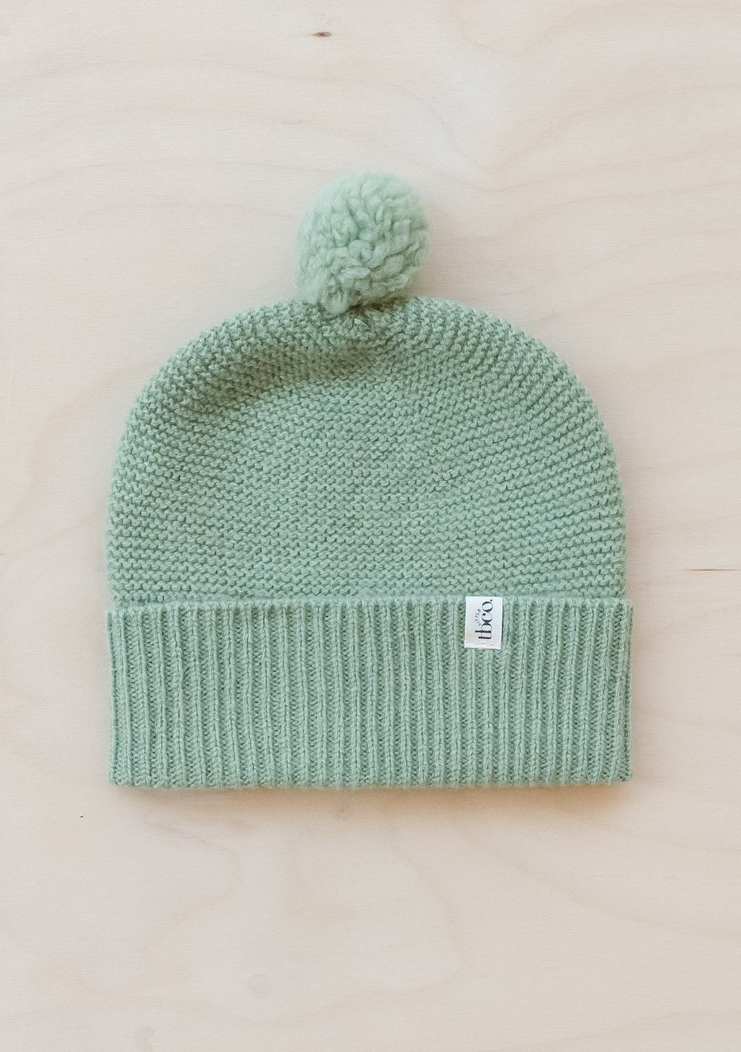 TBCo Merino Wool Baby Beanie in pistachio green with pom-pom, knitted design and ribbed trim