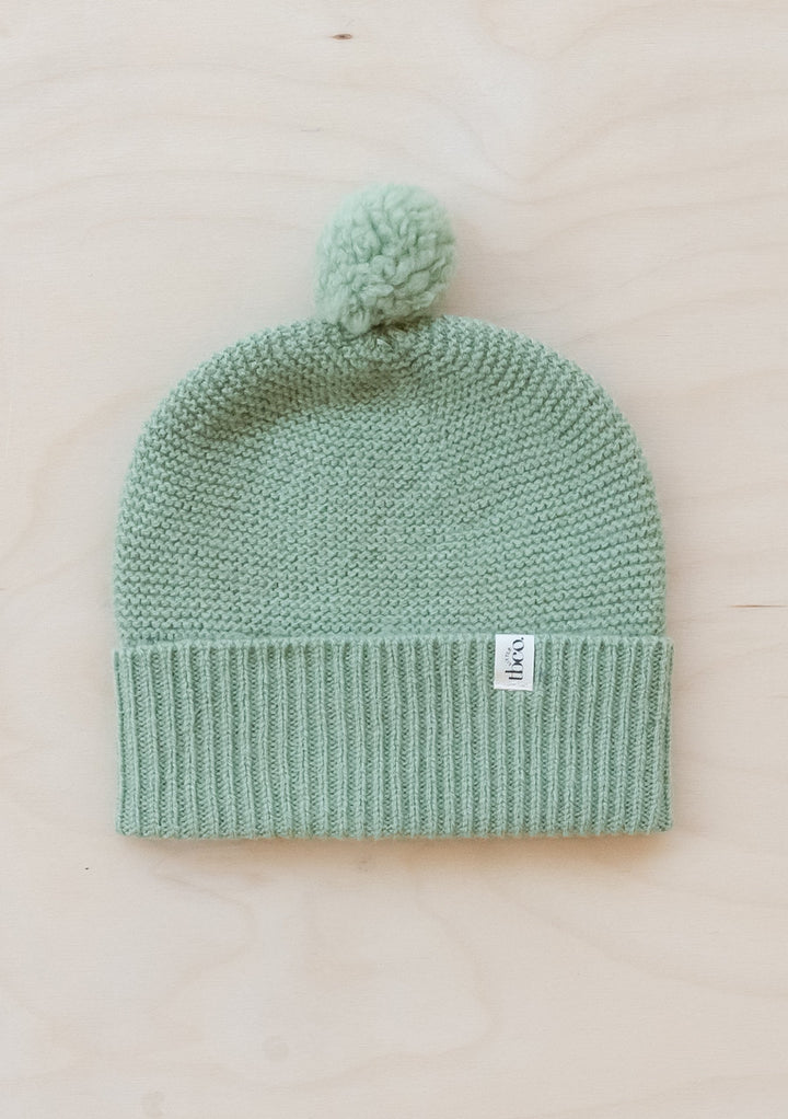 TBCo Merino Wool Baby Beanie in pistachio green with pom-pom, knitted design and ribbed trim