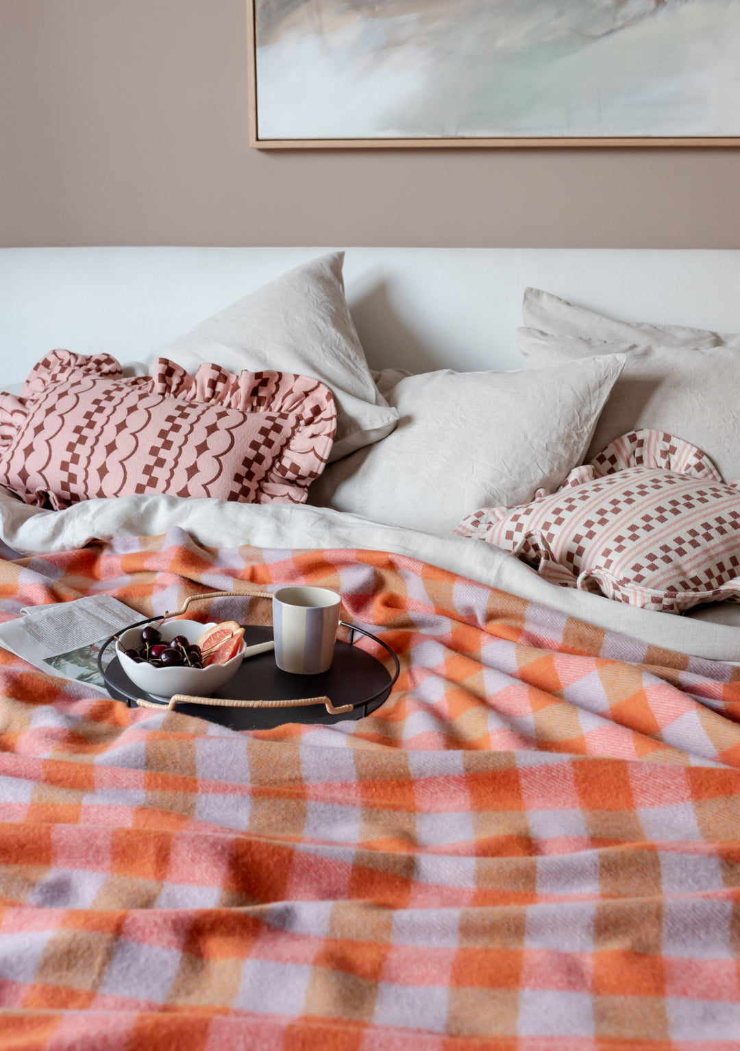 TBCo Cotton Cushion Cover in Pink Ruffle styled on bed with plaid blanket, white pillows and breakfast tray