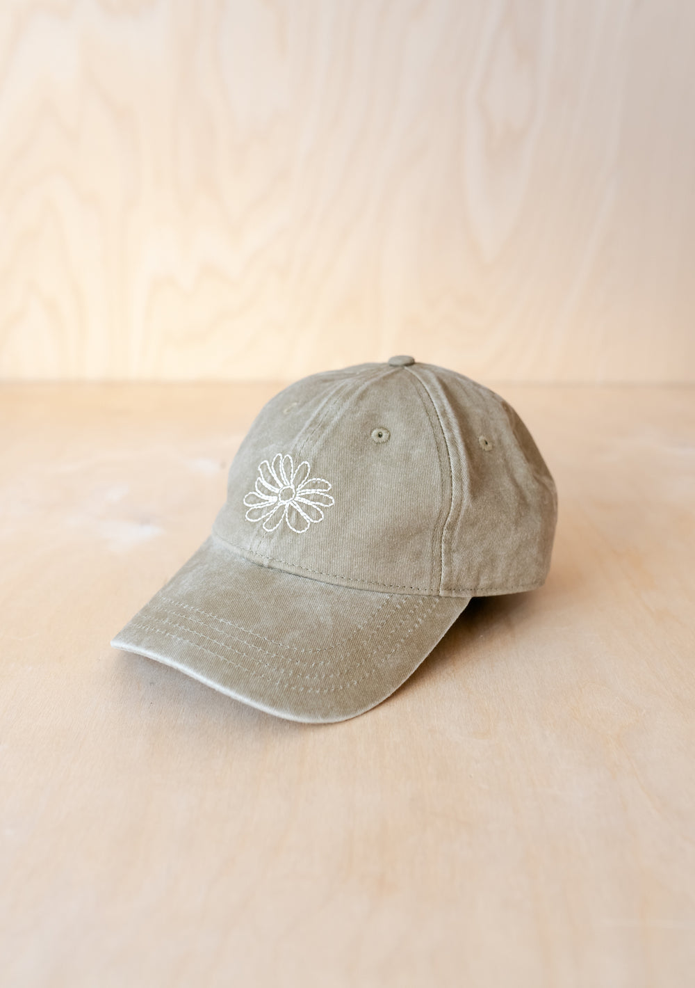 TBCo Recycled Cotton Cap in Flora featuring sage green fabric with white embroidered daisy design and adjustable strap