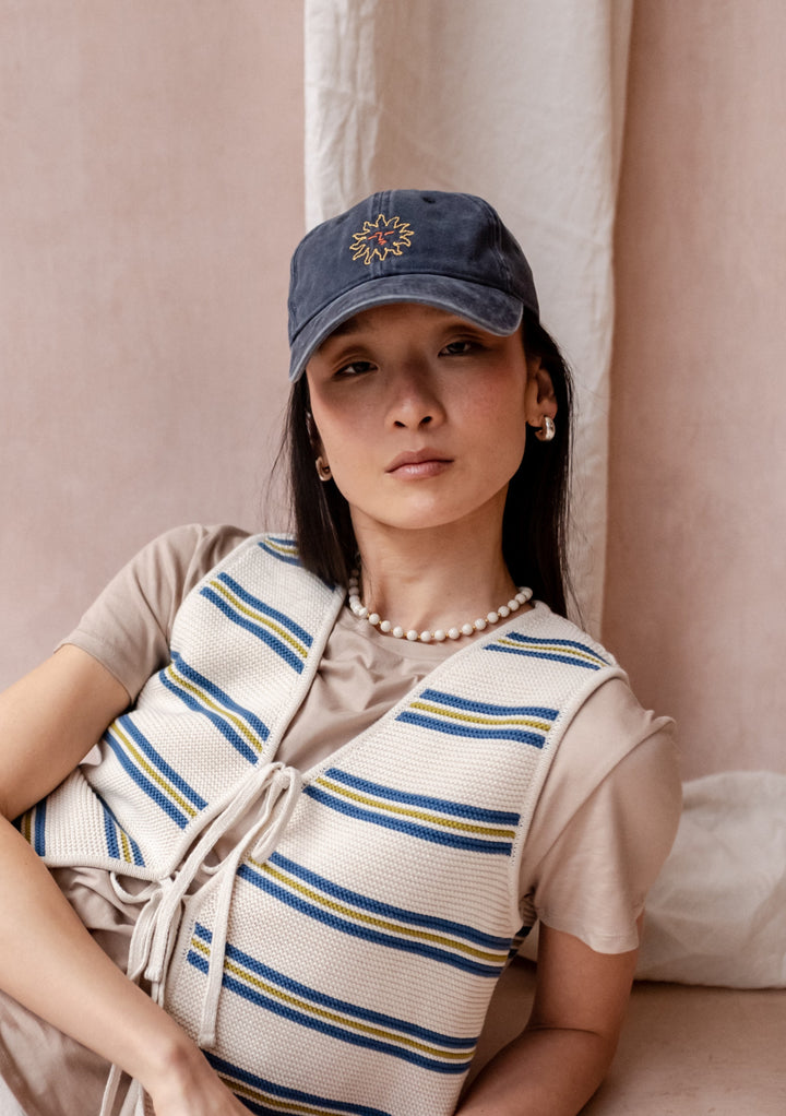 TBCo Recycled Cotton Cap in Sun with embroidered floral detail, adjustable blue cotton baseball cap with breathable design