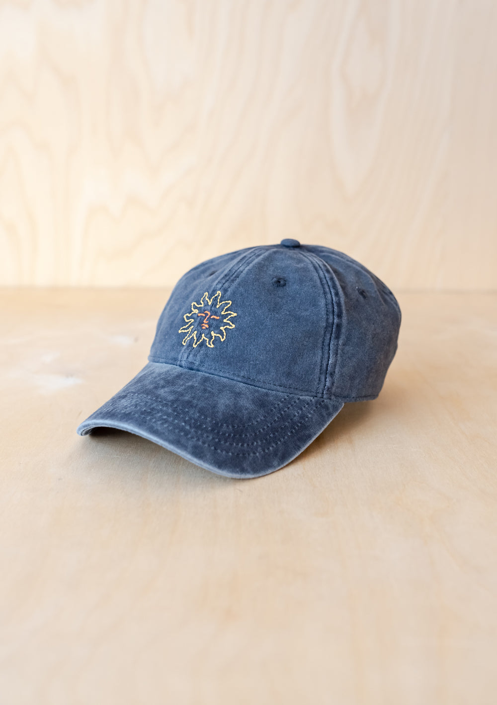 TBCo Recycled Cotton Cap in Sun featuring blue denim fabric with embroidered floral detail and adjustable strap