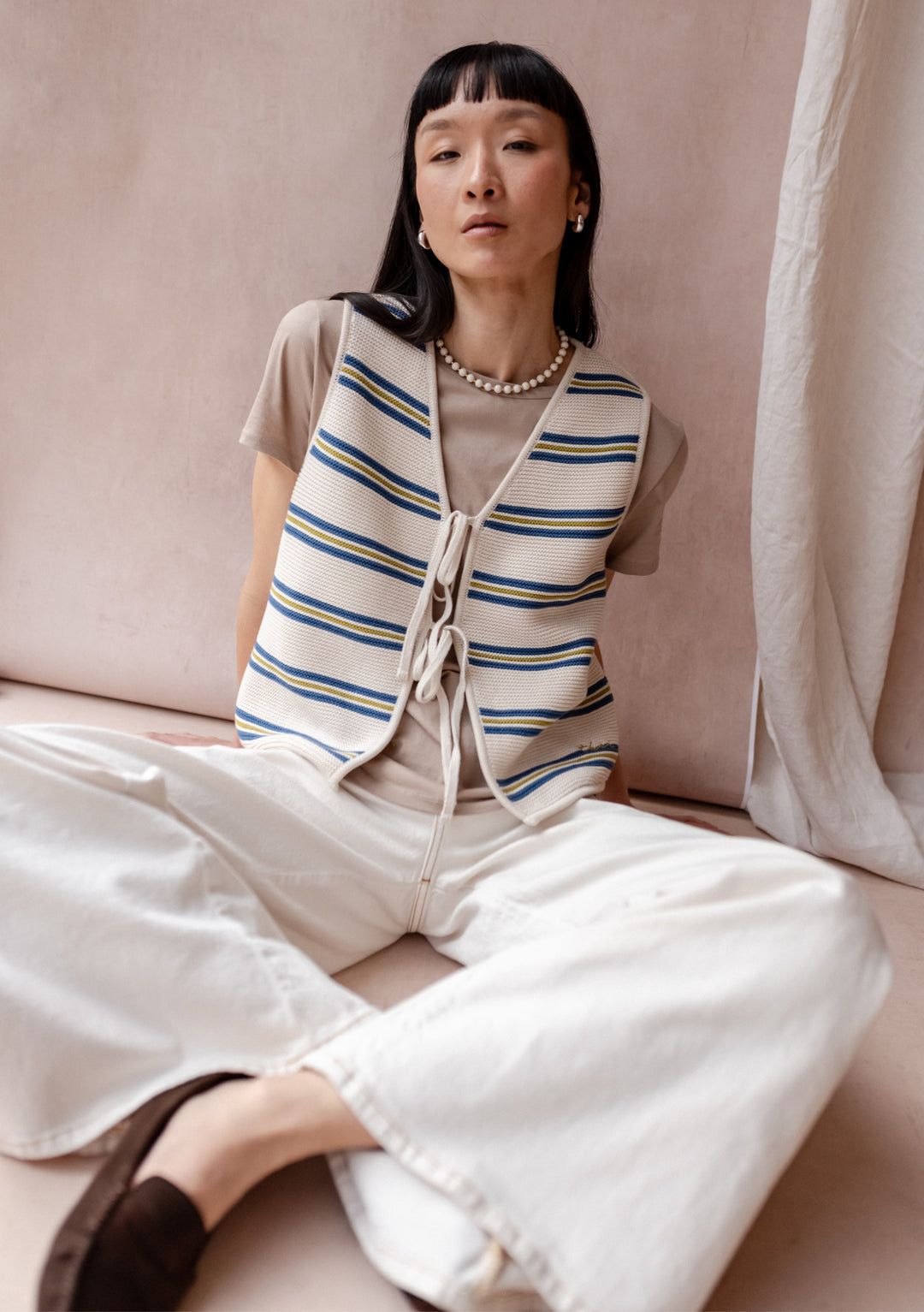 TBCo Cotton Knitted Vest in cream with blue and green stripes, featuring adjustable front ties and relaxed fit styling