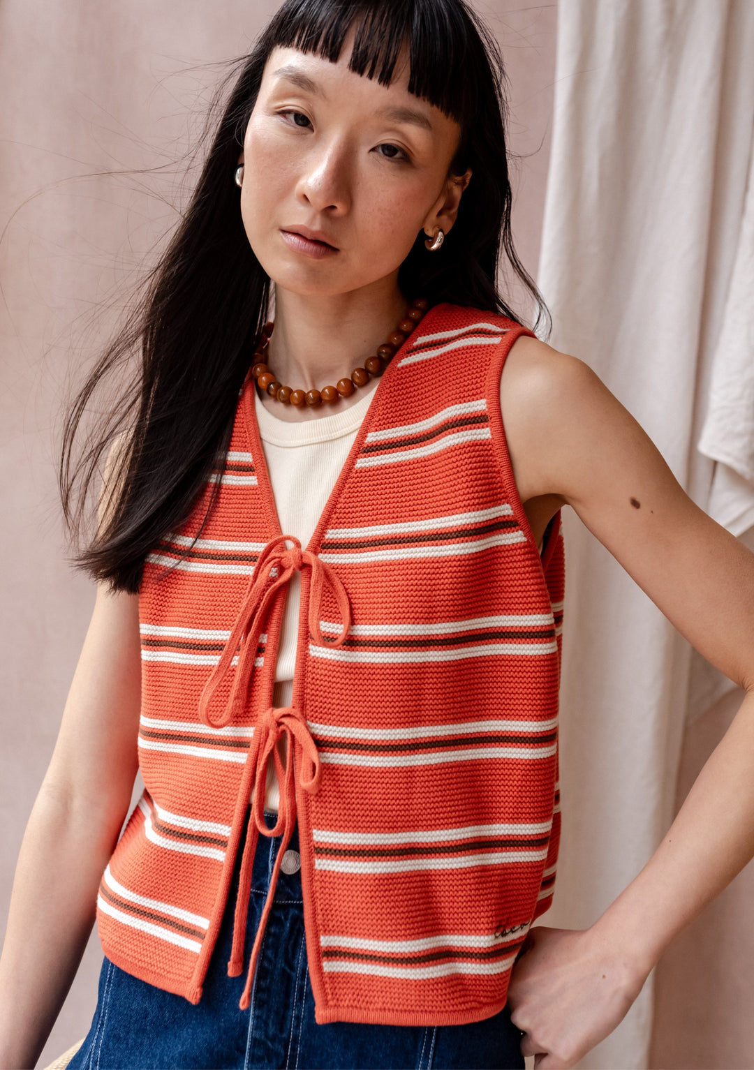 TBCo Cotton Knitted Vest in tangerine and cream stripes, featuring dual front ties and garter stitch pattern