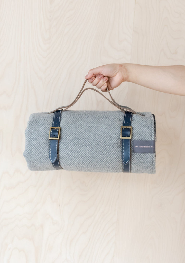 TBCo Picnic Blanket with Leather carrier with sturdy brass buckles, designed for securely carrying rolled-up wool picnic blankets. A timeless and practical accessory for stylish outdoor adventures and easy transport.