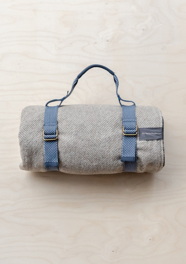 TBCo Recycled Picnic Carrier in grey with adjustable navy straps and brass buckles, designed for portable blanket transport