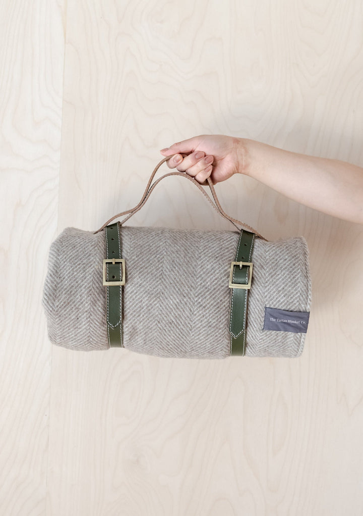 TBCo Picnic Blanket with Leather carrier with sturdy brass buckles, designed for securely carrying rolled-up wool picnic blankets. A timeless and practical accessory for stylish outdoor adventures and easy transport.