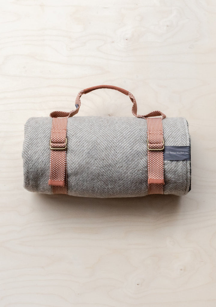 TBCo Recycled Picnic Carrier in grey wool with rose gold straps, rolled and secured with adjustable buckle fasteners
