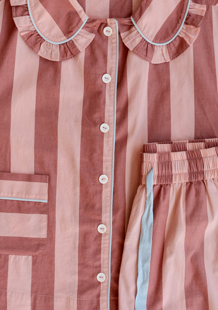 TBCo Cotton Pyjamas in pink and red stripe with ruffled collar detail and blue piping, featuring traditional button-down design