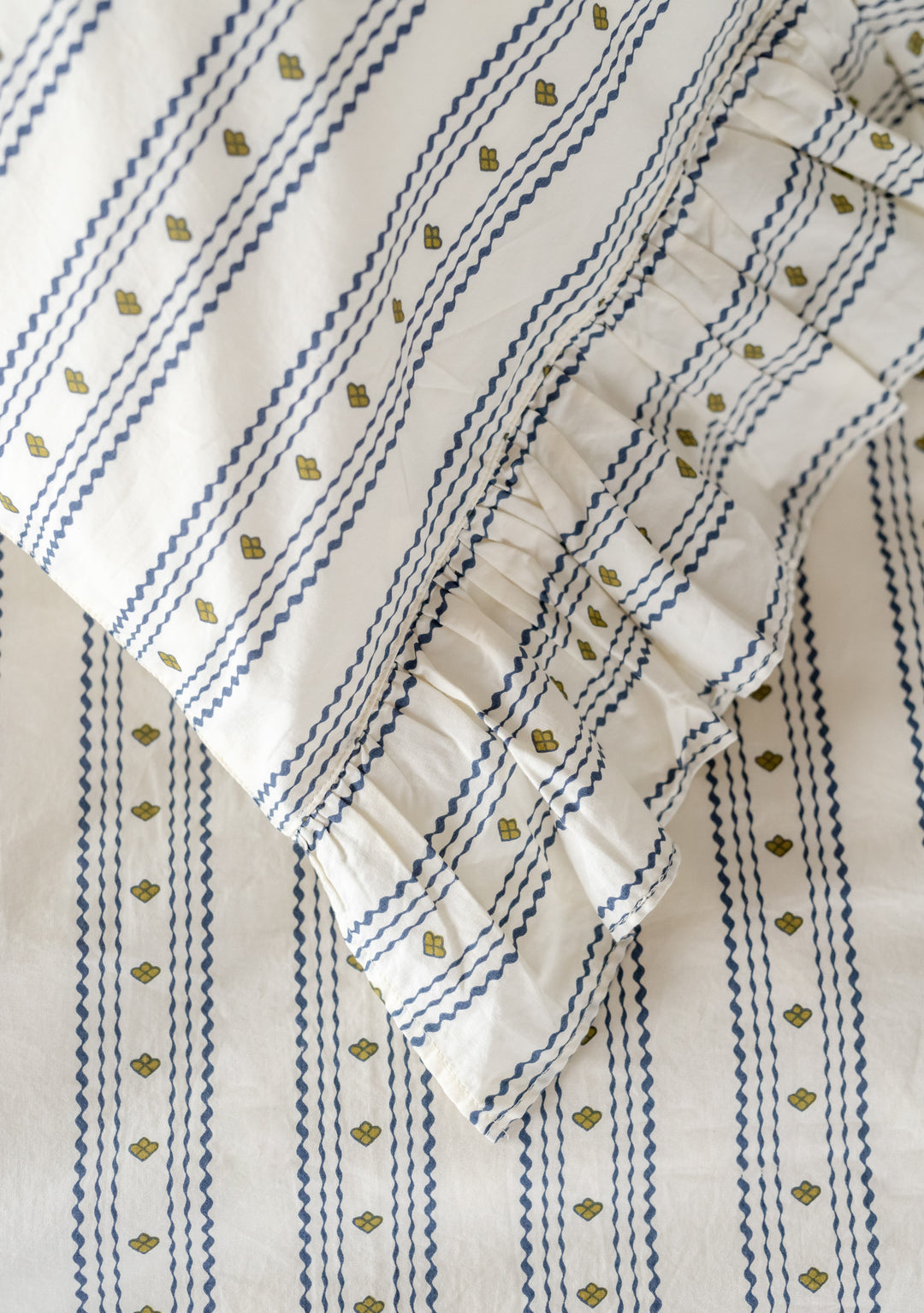 TBCo Cotton Duvet Cover featuring navy zigzag stripes with green accents and delicate ruffle trim detail on white background