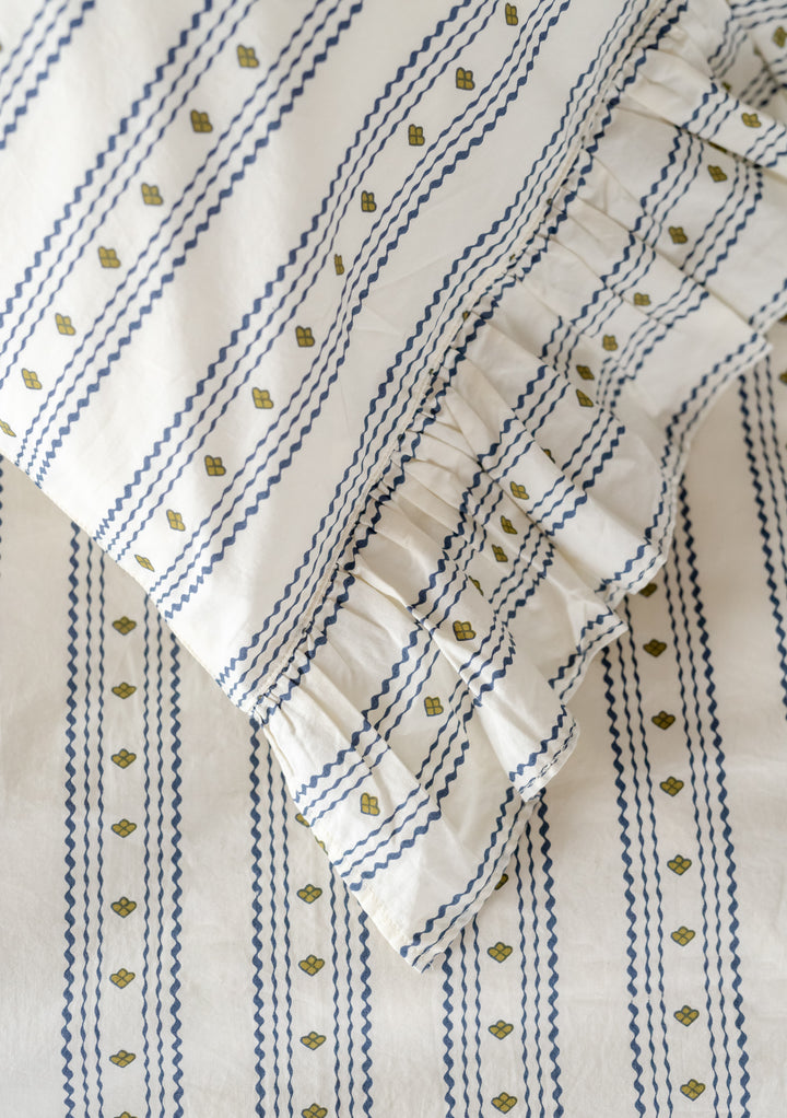 TBCo Cotton Duvet Cover featuring navy zigzag stripes with green accents and delicate ruffle trim detail on white background