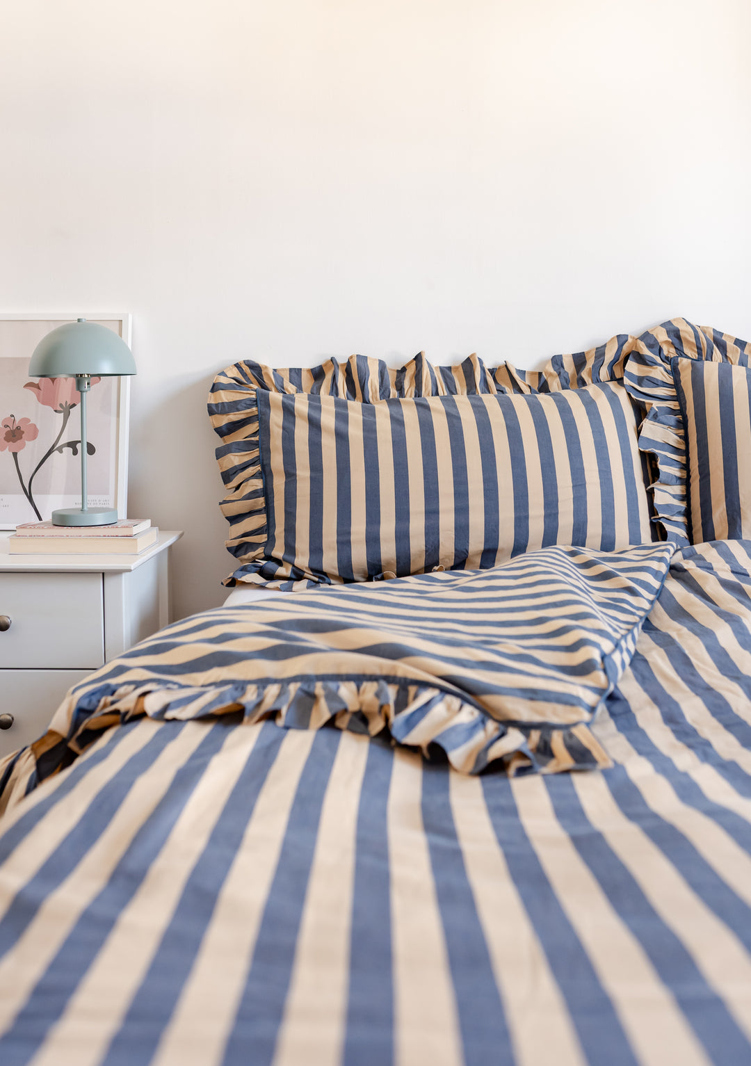 Cotton Duvet Cover in Navy Stripe by TBCo featuring soft cotton poplin with ruffled edges on a neatly made bed.