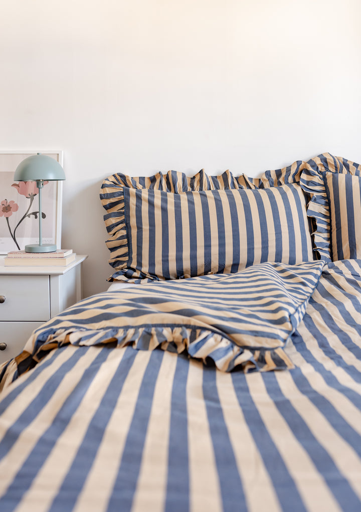 Cotton Duvet Cover in Navy Stripe by TBCo featuring soft cotton poplin with ruffled edges on a neatly made bed.
