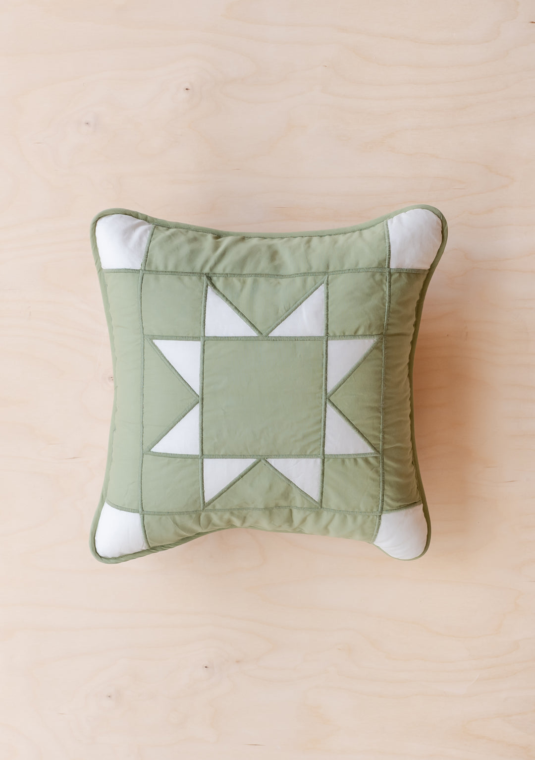 Quilted Cushion Cover in Reversible Celestial Checkerboard by TBCo in soft green and cream with quilted texture.