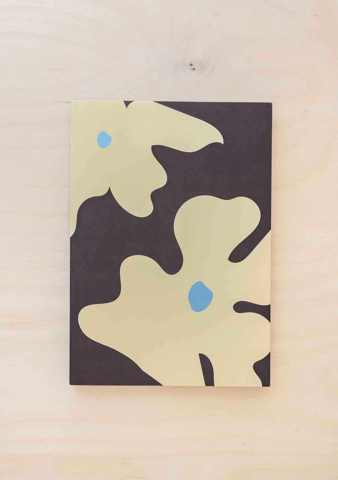 TBCo Flora Notebook featuring abstract cream flowers with blue accents on charcoal grey background, stylish A5 paper cover design