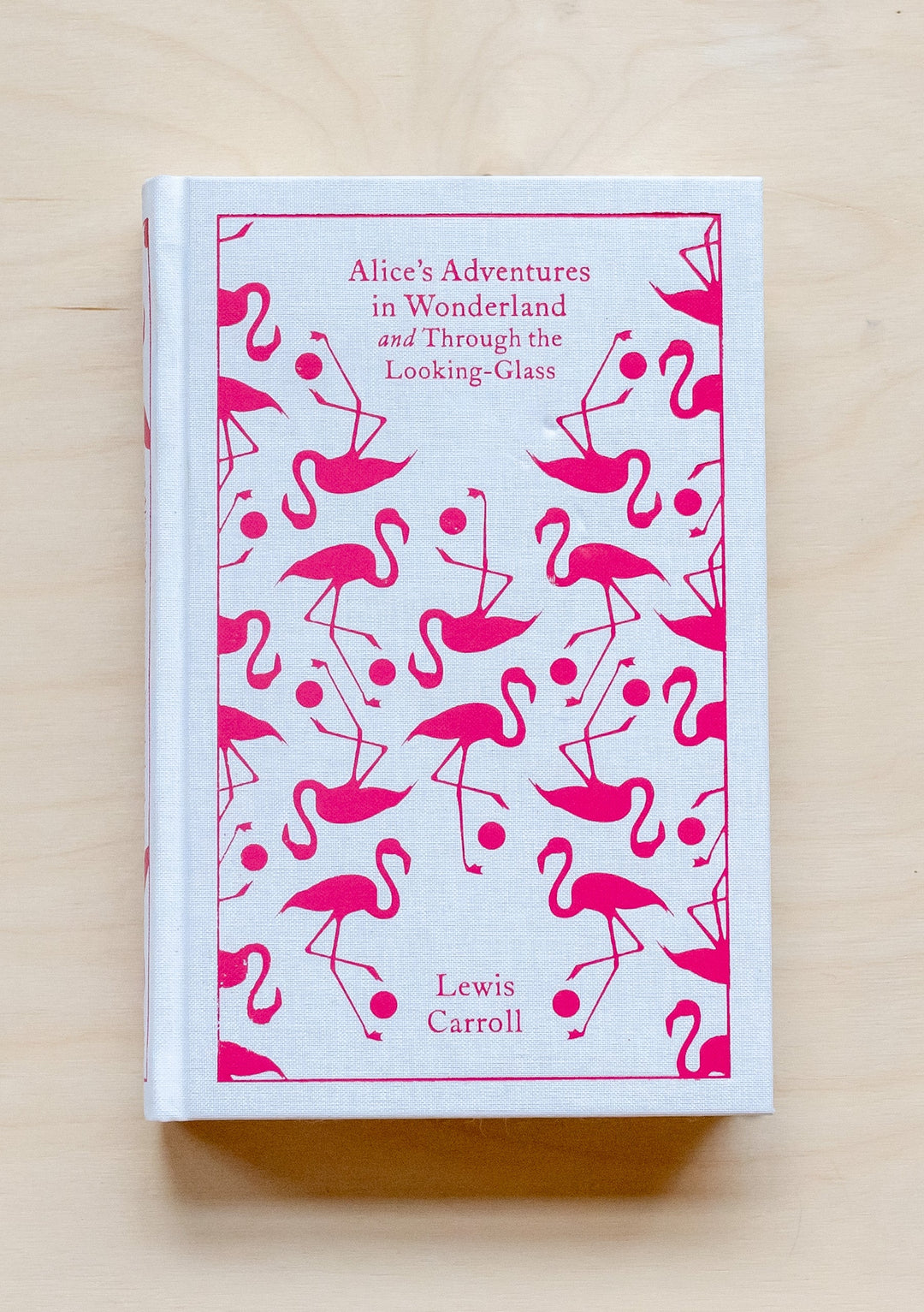 TBCo Alice's Adventures in Wonderland hardback book with pink flamingo pattern on white cloth cover, Penguin Clothbound Classics edition