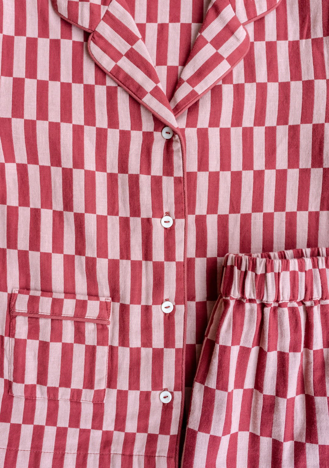TBCo Cotton Kids Pyjamas in Rose Checkerboard pattern featuring collared neckline, front buttons and side pockets in pink and red checks
