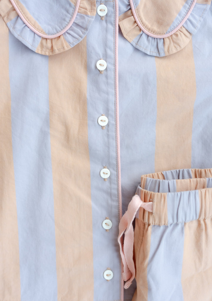 TBCo Cotton Kids Pyjamas featuring orange and lilac stripes with ruffled collar and button-down design, close-up detail