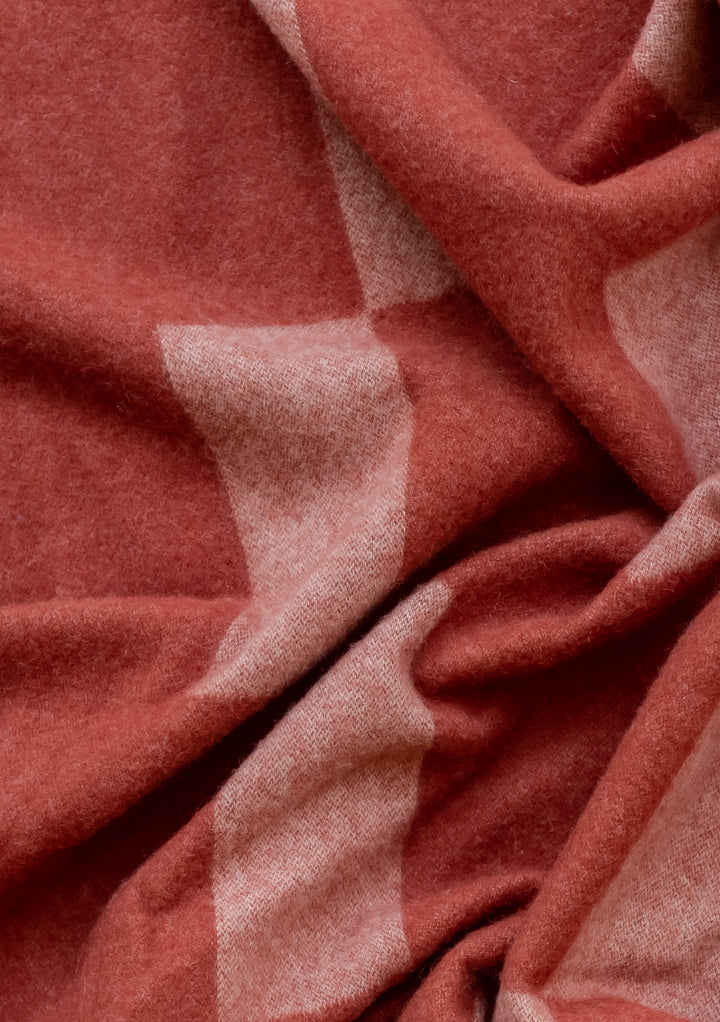 Close-up texture of TBCo Lambswool Blanket in Apricot Checker showing soft woven fabric with geometric pattern detail