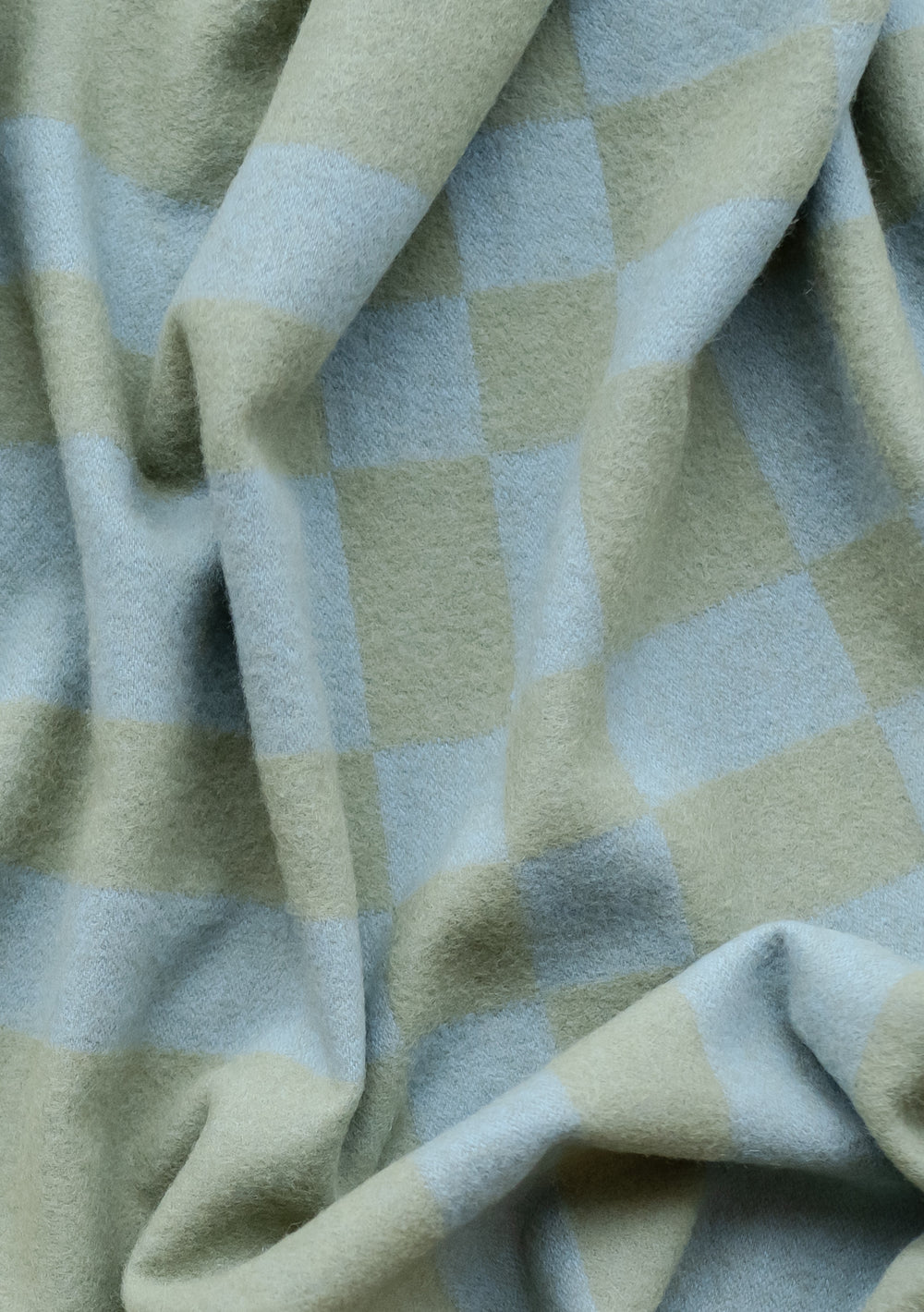 TBCo Lambswool Blanket in Blue Pillar Check featuring soft, textured wool in sage green and powder blue check pattern