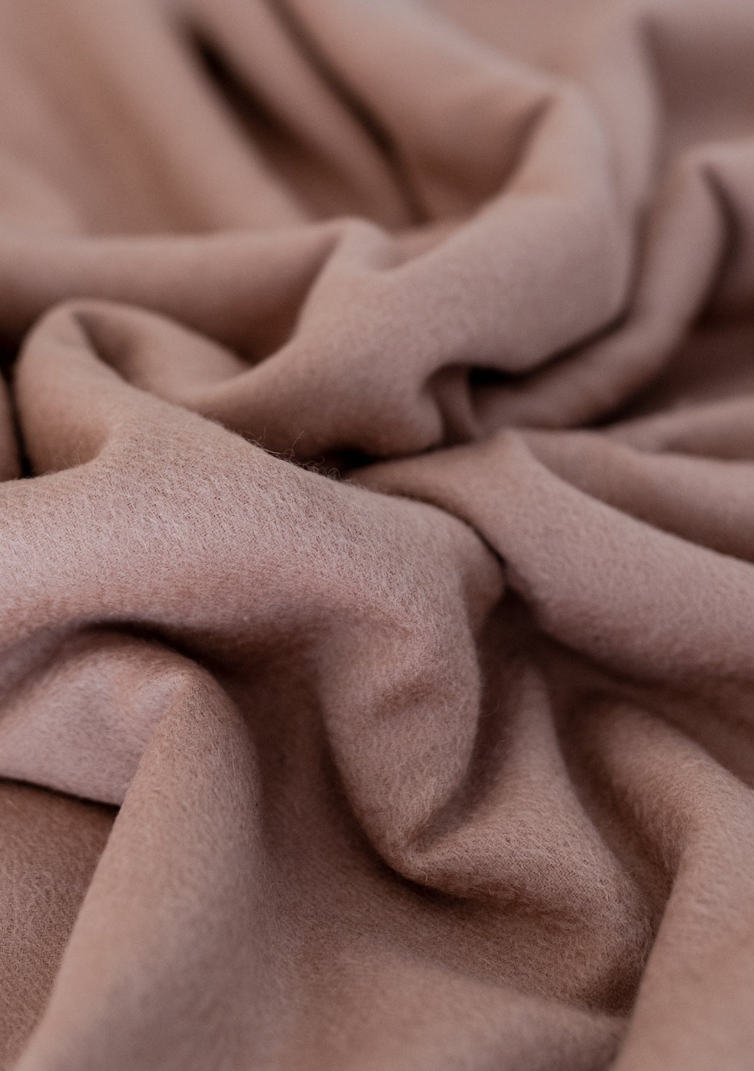 Close-up texture detail of TBCo Lambswool Oversized Scarf in Blush showing soft, draped wool fabric with gentle folds