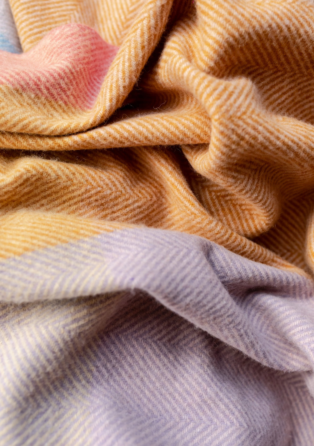 Close-up texture detail of TBCo Recycled Wool Blanket in Mustard Frame Check showing herringbone weave and colour transitions