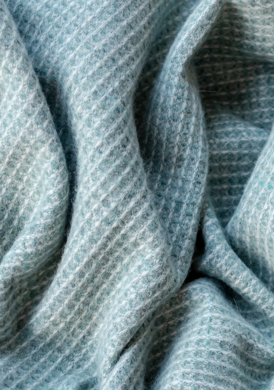 Close-up texture detail of TBCo Recycled Wool Waffle Blanket in Sage showing soft, textured waffle weave pattern