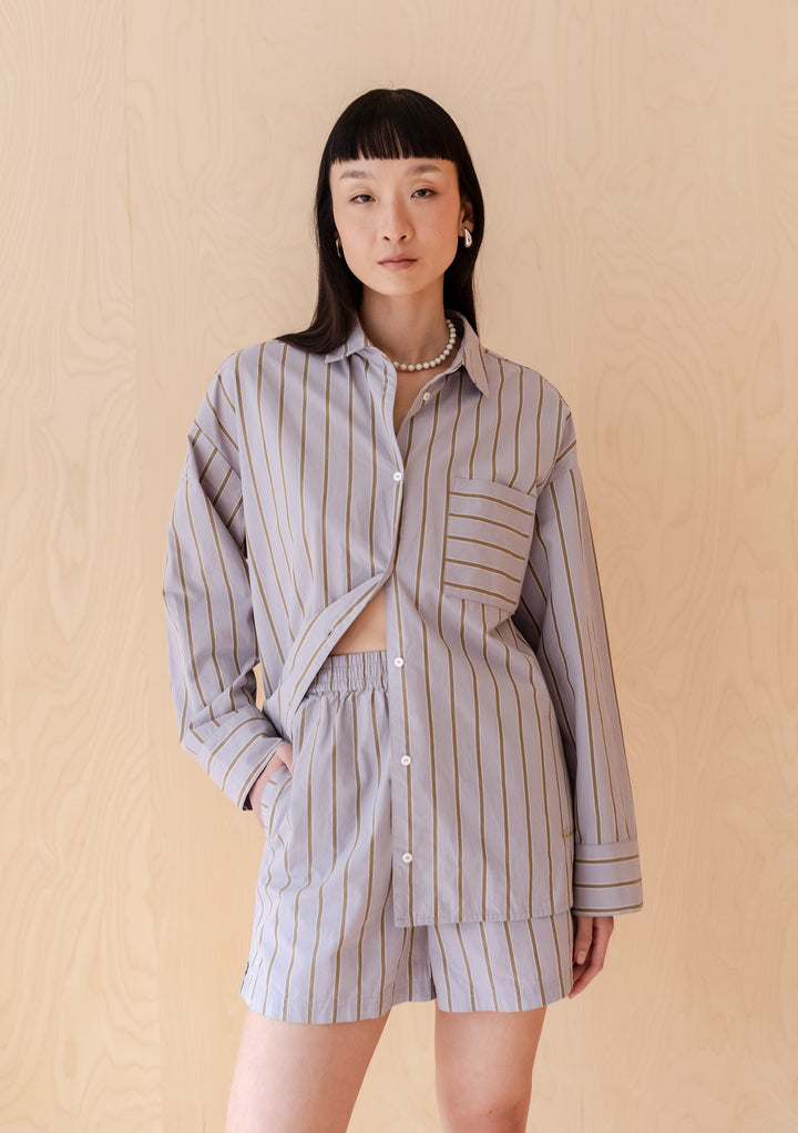 TBCo Cotton Shirt in Lilac Stripe features oversized fit with olive stripes, shown with matching shorts against wooden backdrop