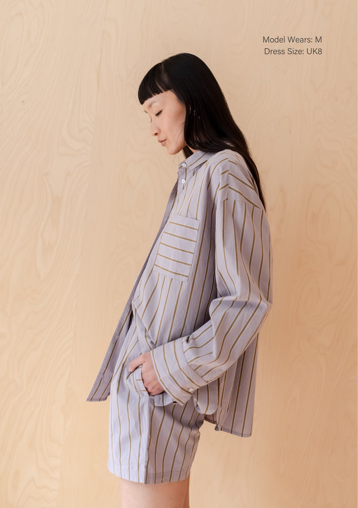 TBCo Cotton Shirt in Lilac Stripe, oversized fit with olive stripes, shown in relaxed side profile against beige backdrop