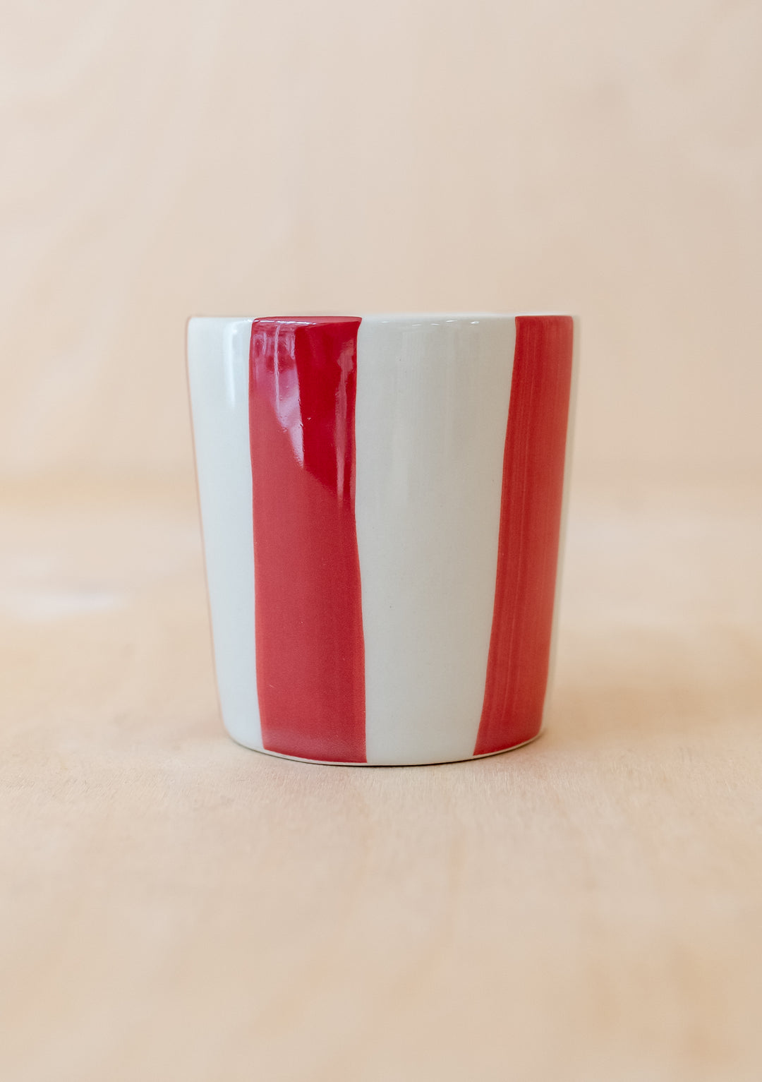 Handcrafted TBCo Red Stripe Mug featuring vertical red and white stripes on a ceramic handleless design with matte finish