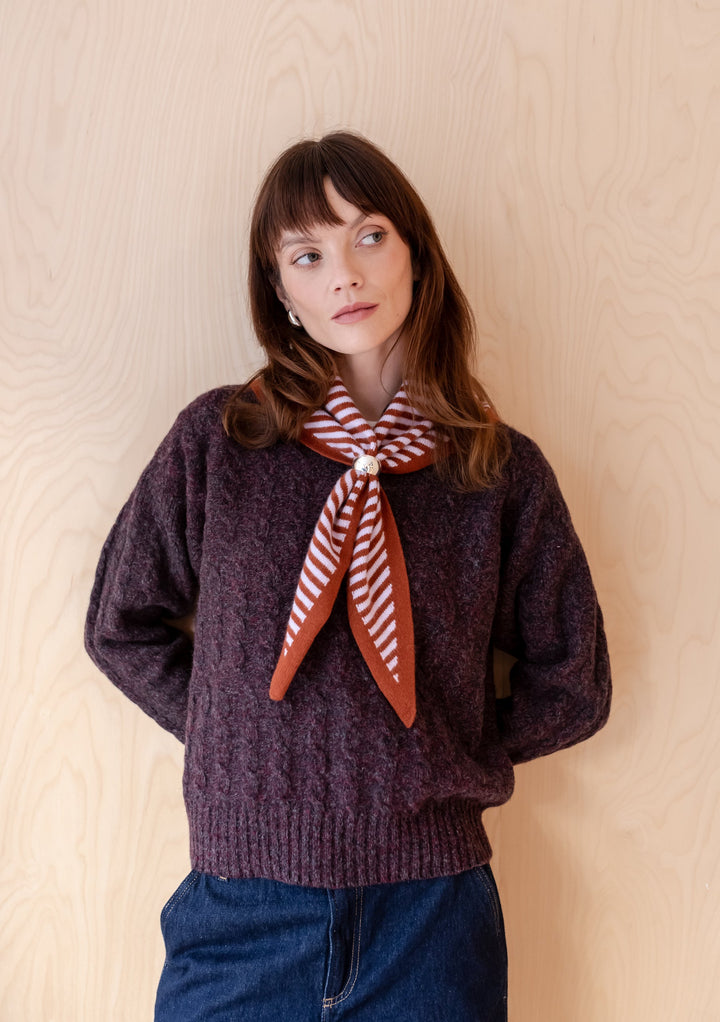 TBCo Merino Triangle Scarf in lilac and rust stripes styled with purple jumper against wooden background
