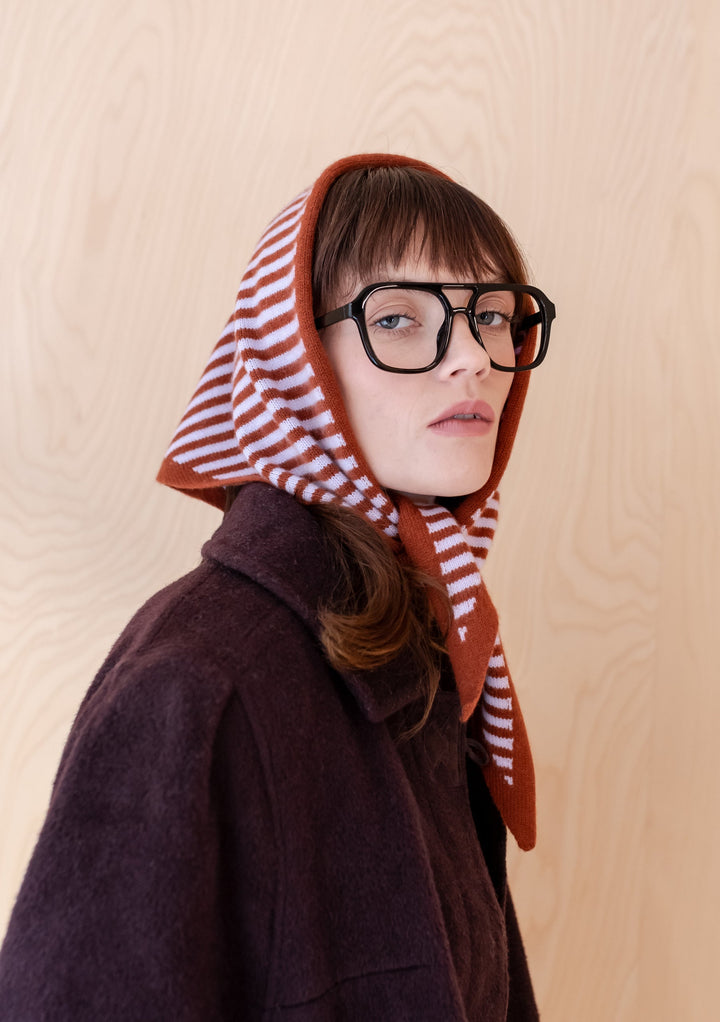 TBCo Merino Triangle Scarf in lilac and rust stripes styled as a hood with dark winter coat, showcasing versatile styling options