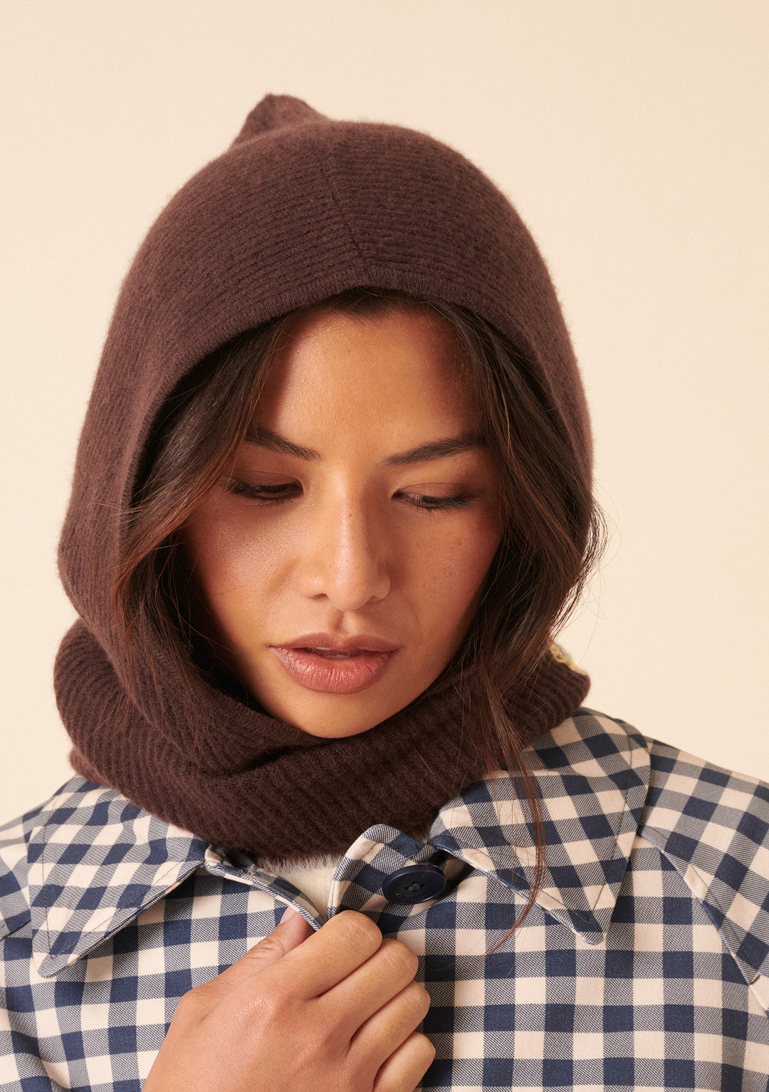Model wearing the NC x TBCo Latte Floral Wool Hood by TBCo in brown merino wool with relaxed check jumper