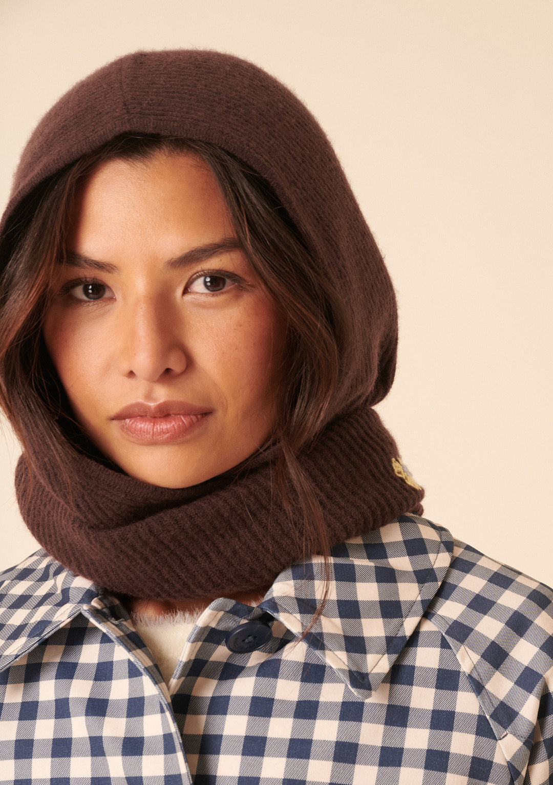 Woman wearing NC x TBCo Latte Floral Wool Hood in brown merino wool styled with checkered jacket