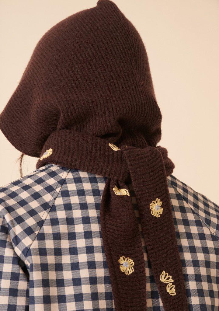 Back view of model wearing NC x TBCo Latte Floral Wool Hood in brown merino with yellow floral embroidery