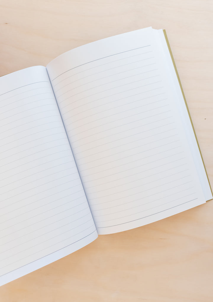 Open TBCo Blue Celestial Notebook showing clean lined pages against neutral background