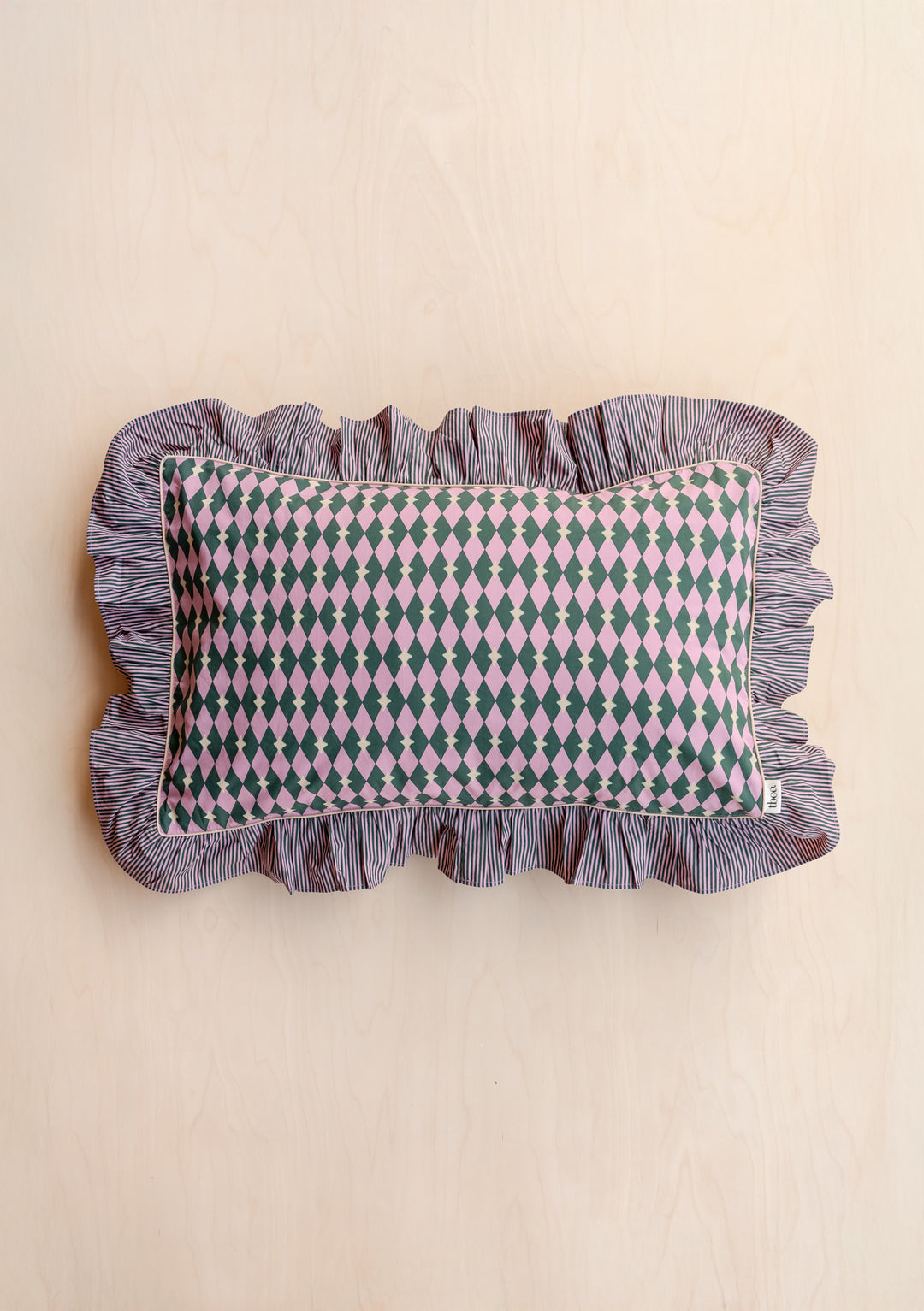 Pair of Cotton Pillowcases in Pink Harlequin by TBCo featuring pink and green harlequin design with ruffled striped trim.