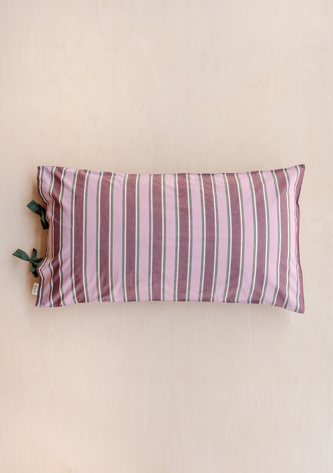 Pair of Cotton Pillowcases in Pink Stripe by TBCo showing soft cotton poplin with delicate tie closures in pink and burgundy stripes