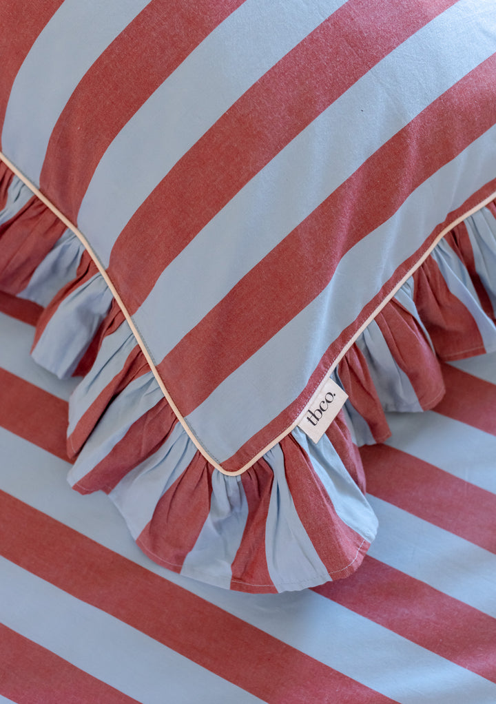 TBCo cotton pillowcases featuring blue and red stripes with delicate ruffled trim, crafted from breathable poplin cotton