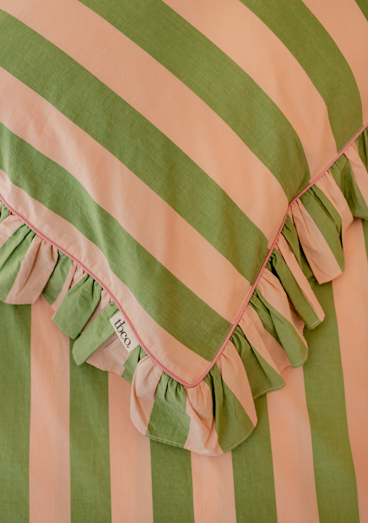 TBCo cotton pillowcases with green and peach stripes featuring delicate ruffled edges, perfect for elegant bedroom styling