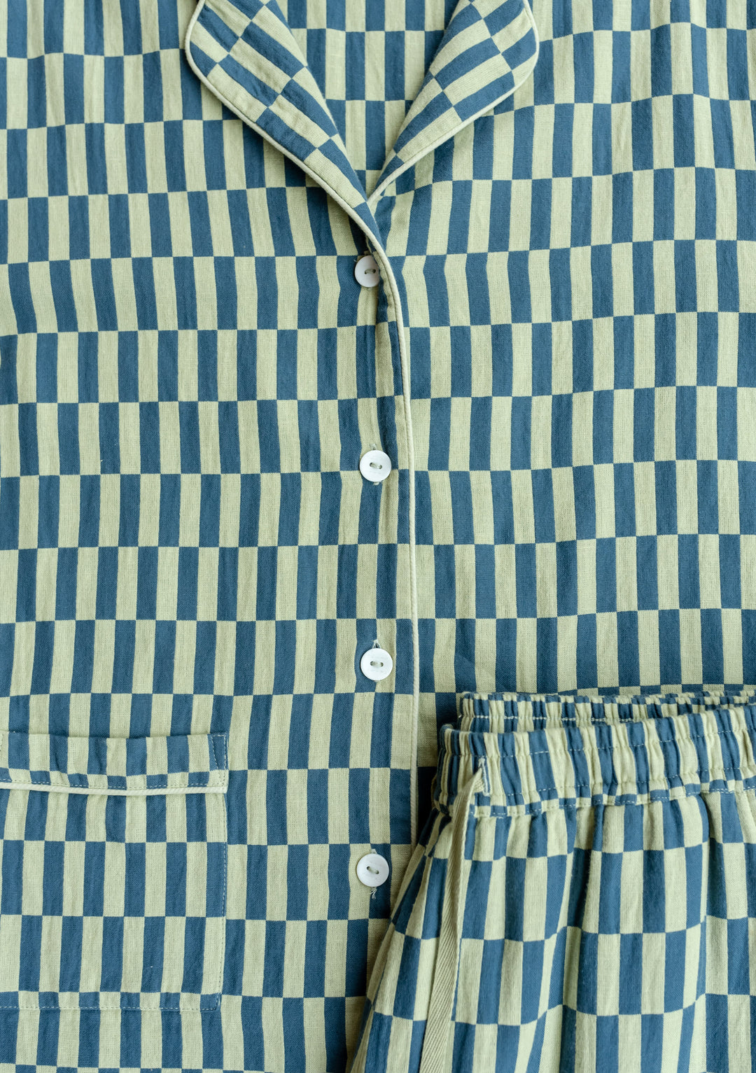 Close-up of TBCo Cotton Pyjamas in green checkerboard pattern, showing collared top with buttons and elastic waist bottoms