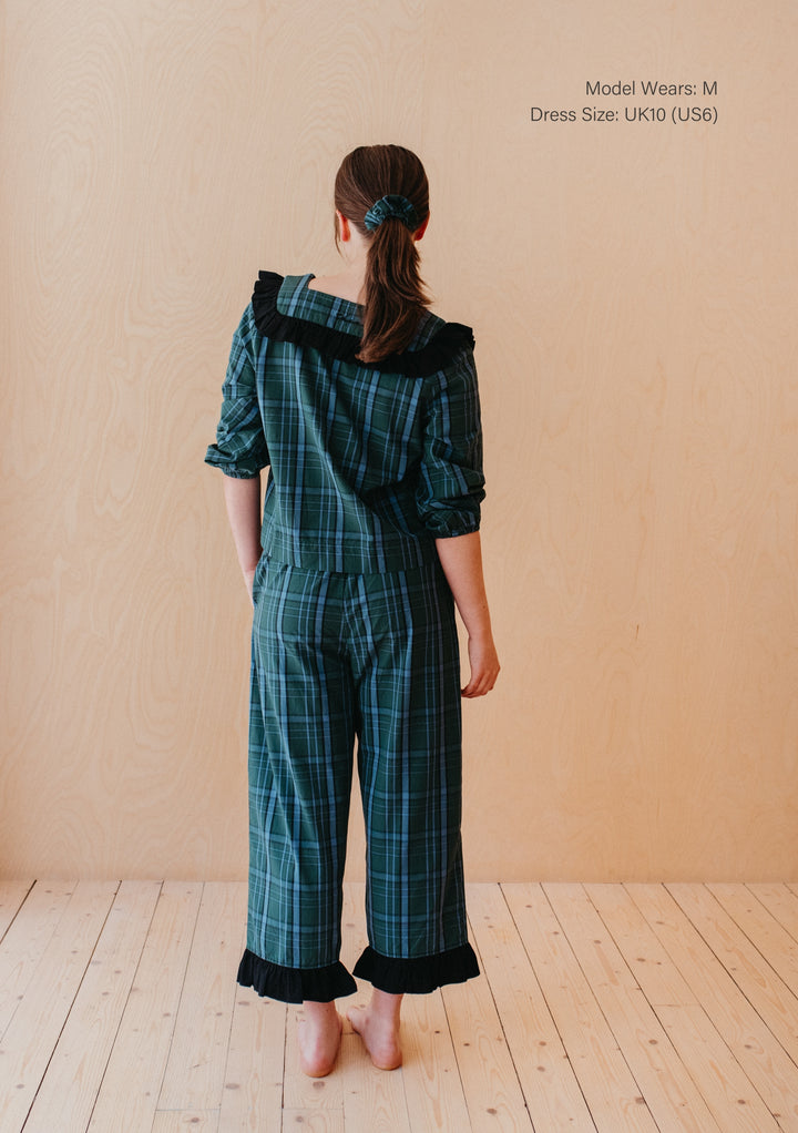 Back view of model wearing TBCo Cotton Pyjamas in Green Tartan with ruffle collar and cropped trousers