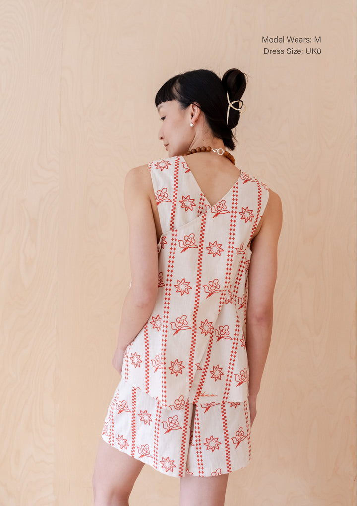TBCo Cotton Short Set in Flora Sun pattern, showing rear view with criss-cross back detail in orange and cream floral print
