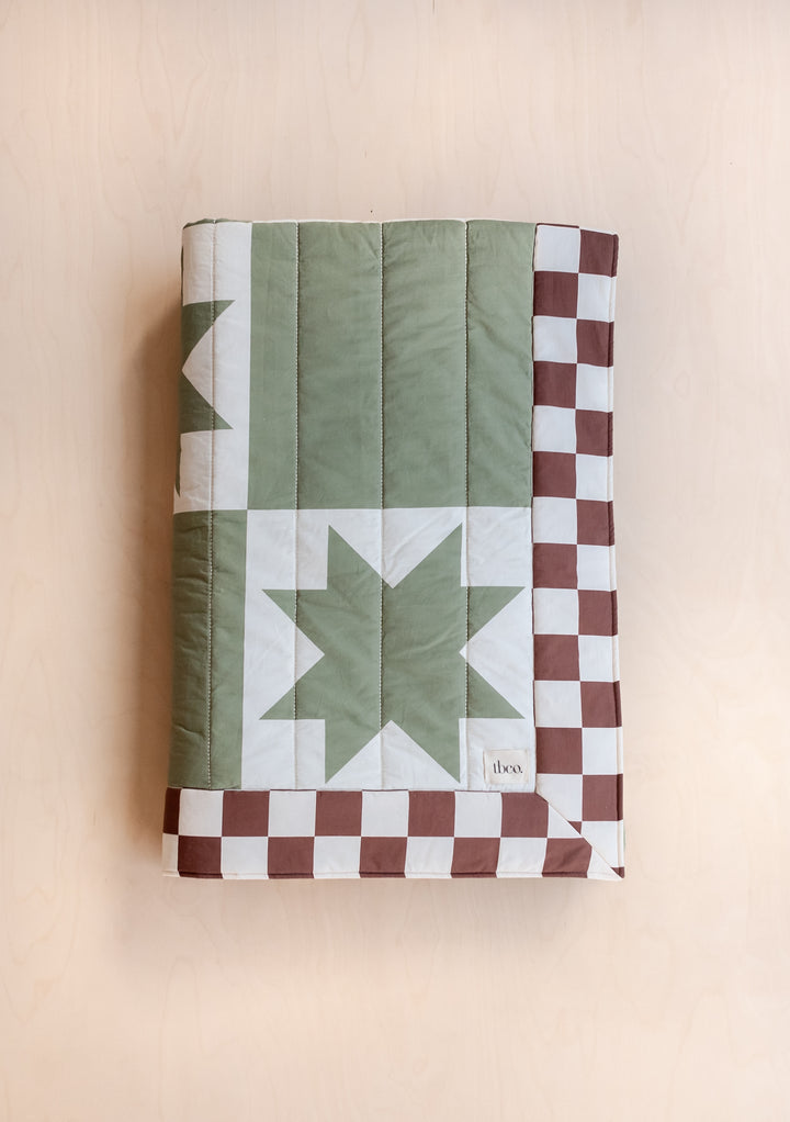 TBCo Quilted Cotton Throw in Celestial Checkerboard featuring green geometric pattern and brown-cream checker border