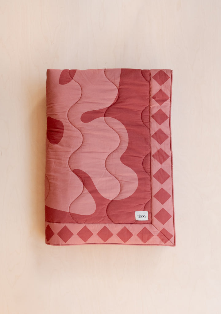 TBCo Quilted Cotton Throw in Flora featuring pink and wine organic pattern with diamond border, cotton and recycled filling