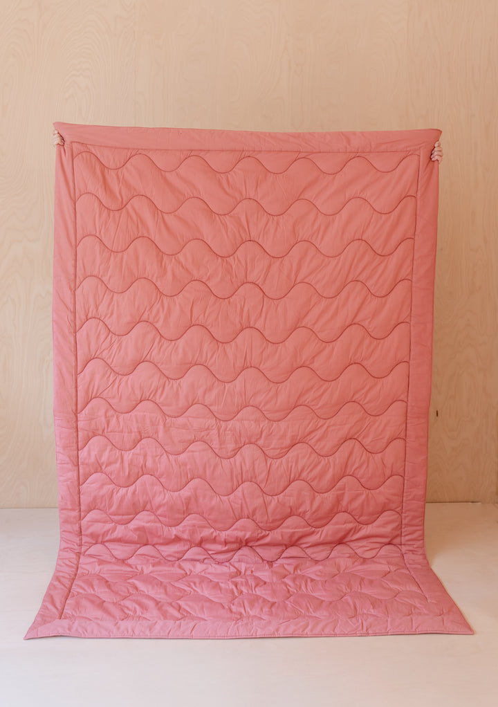 TBCo Quilted Cotton Throw in Flora featuring pink floral pattern with reversible wine coloured side, showcasing wave quilting design