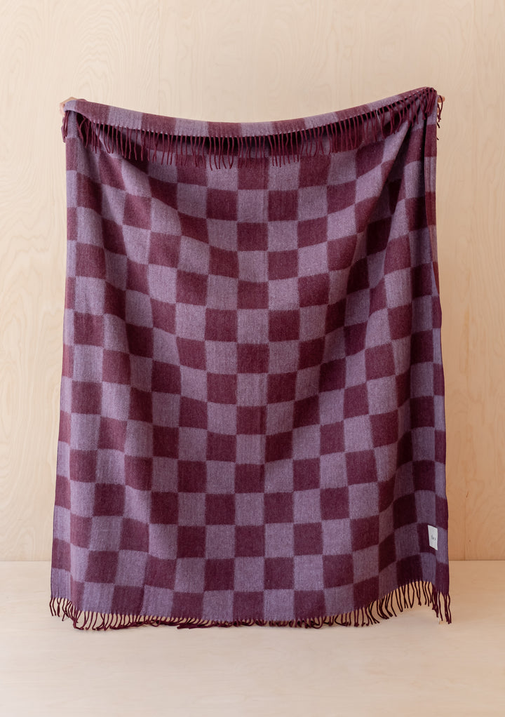 TBCo Recycled Wool Blanket in Burgundy & Lilac Checkerboard with fringed edges, soft and warm for cosy moments.